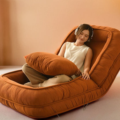Woman listening to music on a floor sofa